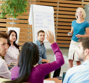 Businesswoman Making Presentation To Office Colleagues